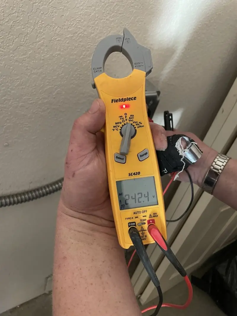 Voltage testing with clamp meter during Recessed Lighting Installation in Medford